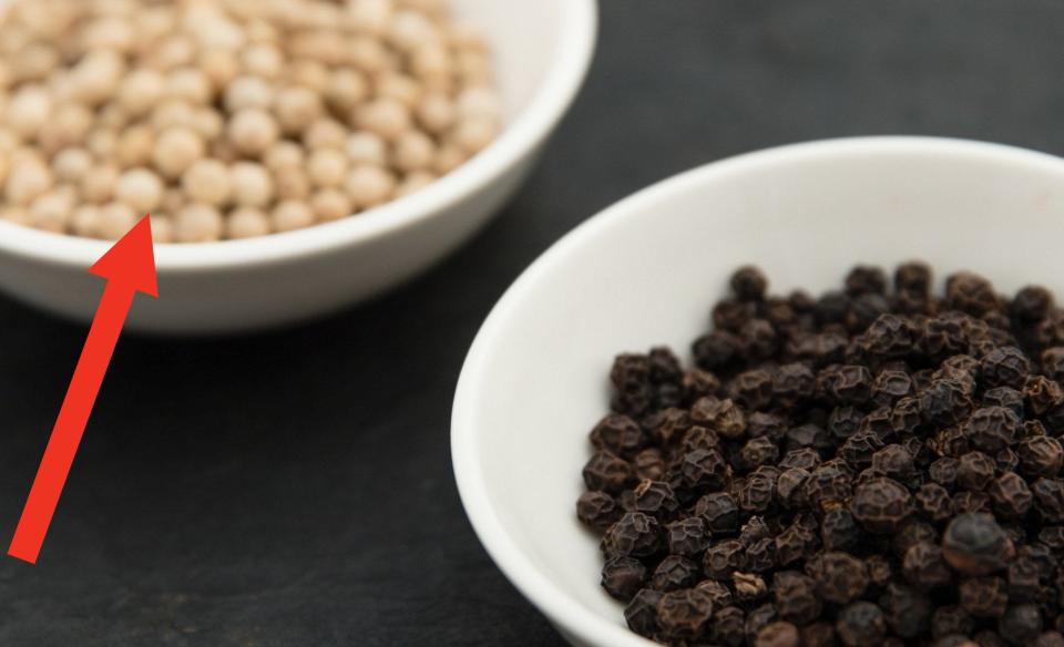 White plates with black and white peppercorns.