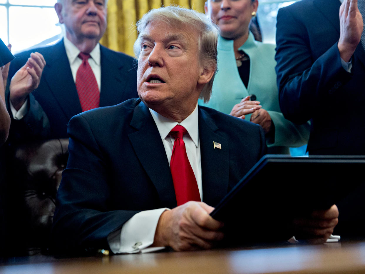 President Trump signs an executive order in the Oval Office: Andrew Harrer/Getty