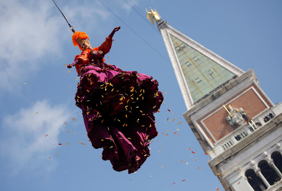 <p>A woman dressed as an “angel” descends on Saint Mark’s Square during the Venice Carnival, Italy Feb. 19, 2017. (Photo: Alessandro Bianchi/Reuters) </p>