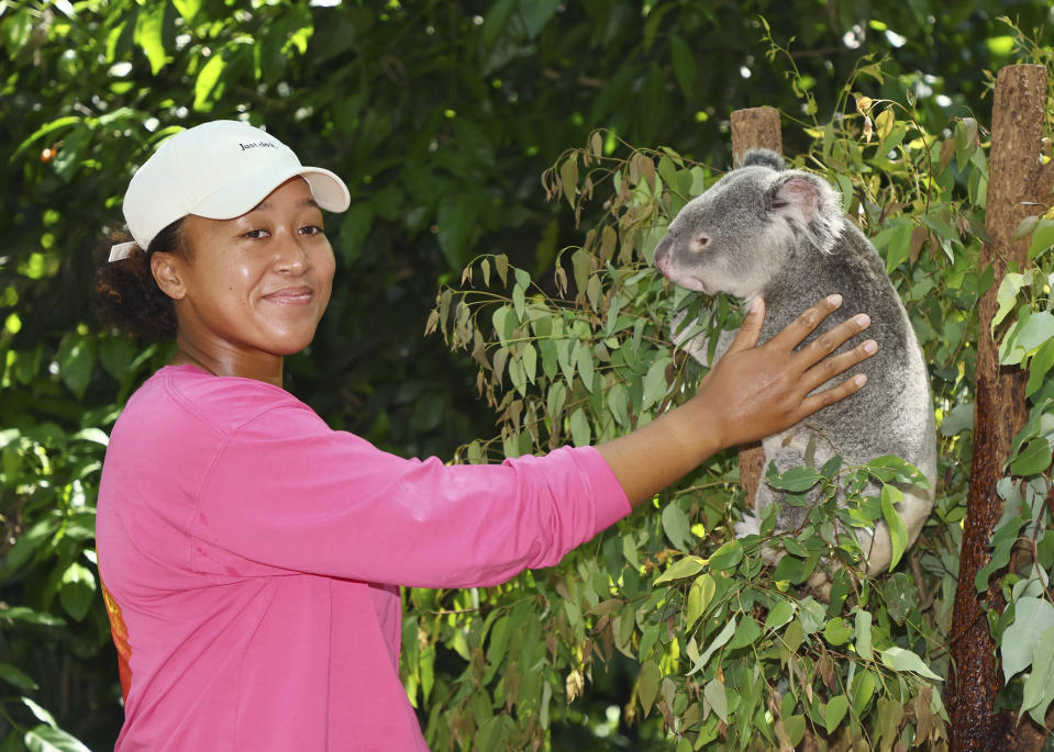 Naomi Osaka of Japan poses with Milton, a koala bear, during a visit to the Lone Pine sanctuary ahead of the Brisbane International tennis tournament in Brisbane, Australia, Friday, Dec. 29, 2023. (AP Photo/Tertius Pickard)