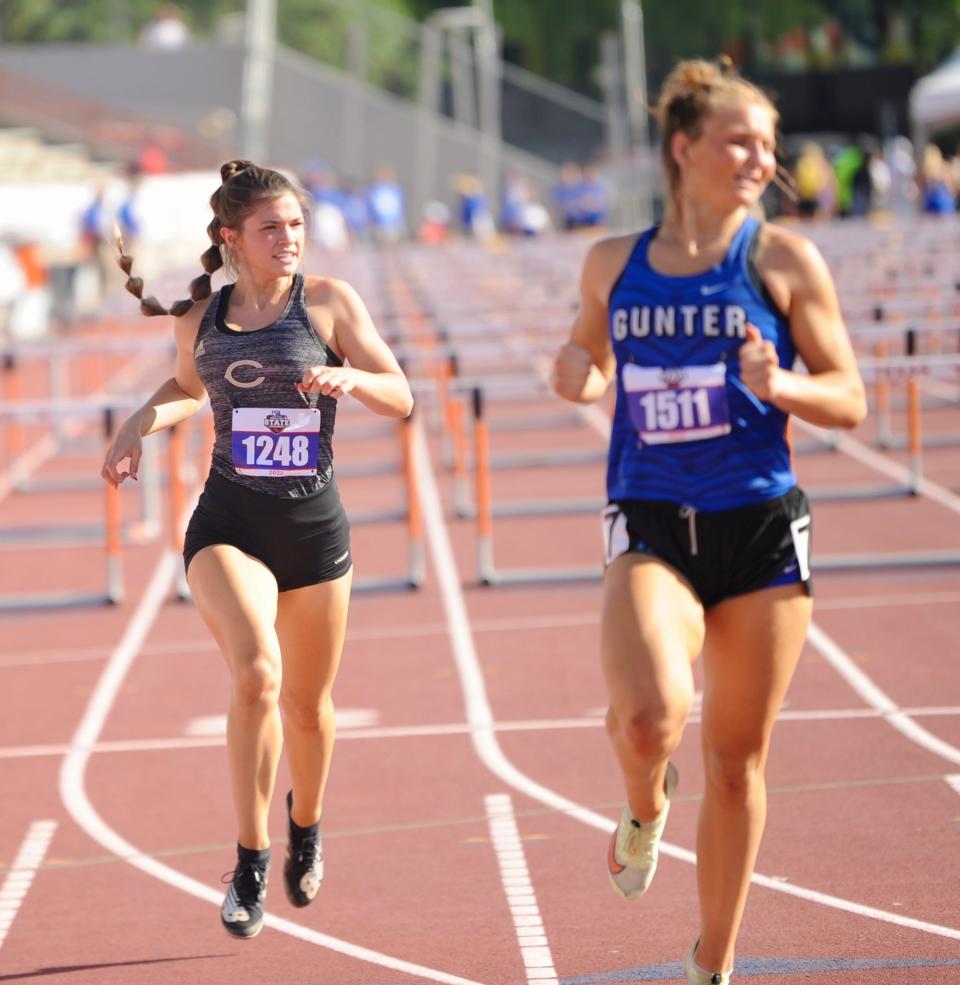 Clyde's Payton Phillips runs the 100 hurdles at the state track and field meet in Austin.