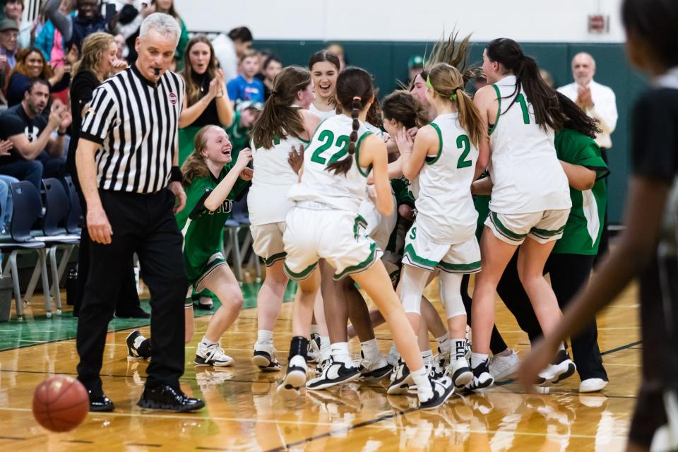 The Sutton girls basketball celebrate after beating Westport to advance to their first-ever Final Four in school history