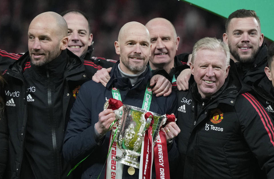 Manchester United's head coach Erik ten Hag, centre, and team members pose with the trophy after the English League Cup final soccer match between Manchester United and Newcastle United at Wembley Stadium in London, Sunday, Feb. 26, 2023. (AP Photo/Alastair Grant)