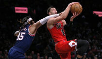 Chicago Bulls guard Zach LaVine (8) is fouled on his way to the basket by Brooklyn Nets' DeAndre Bembry (95) during the first half of an NBA basketball game in New York, Saturday, Dec. 4, 2021. (AP Photo/Noah K. Murray)