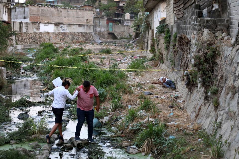 Crime scene investigators at a homicide scene in Acapulco.