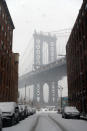 <p>A Brooklyn tower of the Manhattan Bridge is seen from the cobblestone streets of the DUMBO in Brooklyn, New York as a spring storm hit the area on March 21, 2018. (Photo: Gordon Donovan/Yahoo News) </p>