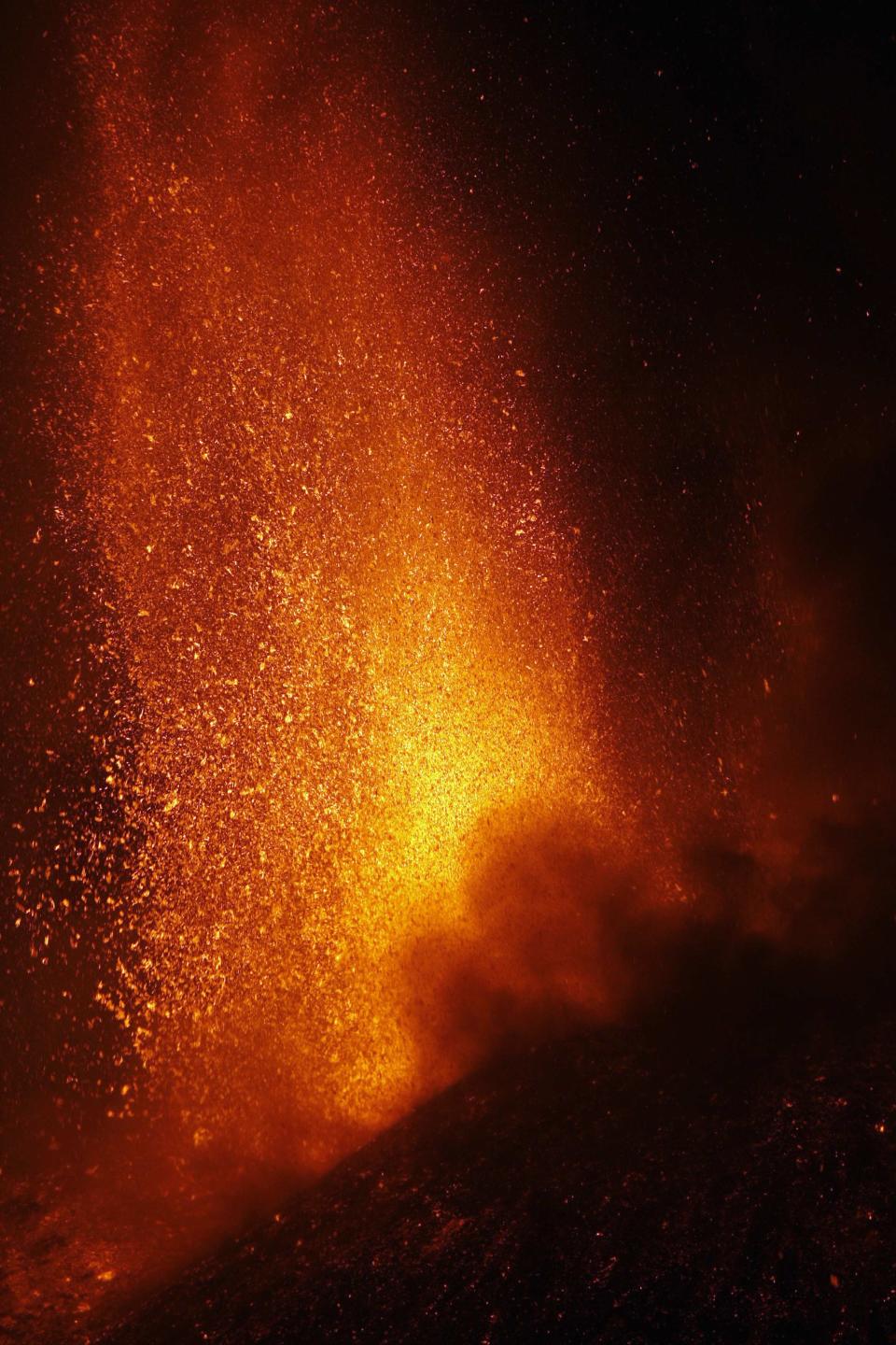 Italy's Mount Etna, Europe's tallest and most active volcano, spews lava as it erupts on the southern island of Sicily November 17, 2013. There were no reports of damage or evacuations in the area and the nearby airport of Catania was operating as normal, local media reported. It is the 16th time that Etna has erupted in 2013. The south-eastern crater, formed in 1971, has been the most active in recent years. REUTERS/Antonio Parrinello (ITALY - Tags: ENVIRONMENT SOCIETY)