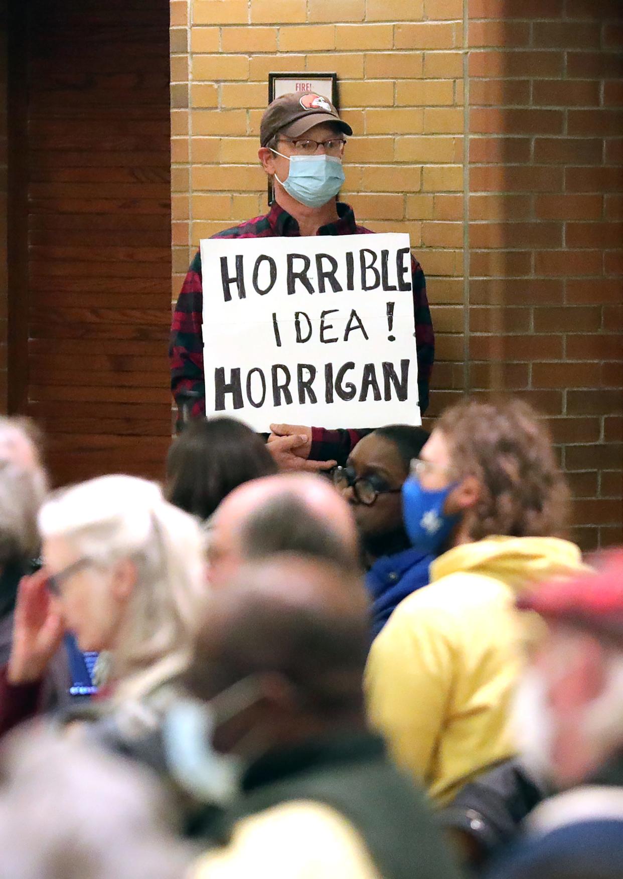 An Akron resident quietly makes his voice heard during a public engagement session discussing the development of the wetlands off White Pond Drive at Zwisler Hall in Akron.