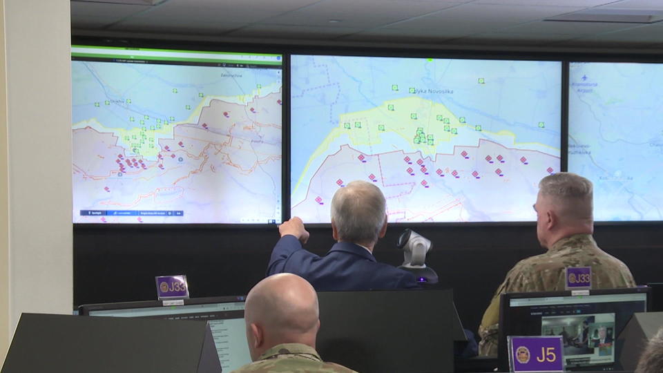 Gen. Mark Milley (right) observes intelligence about the frontlines of Russia's invasion of Ukraine at a global situational awareness facility in the Pentagon.  / Credit: CBS News
