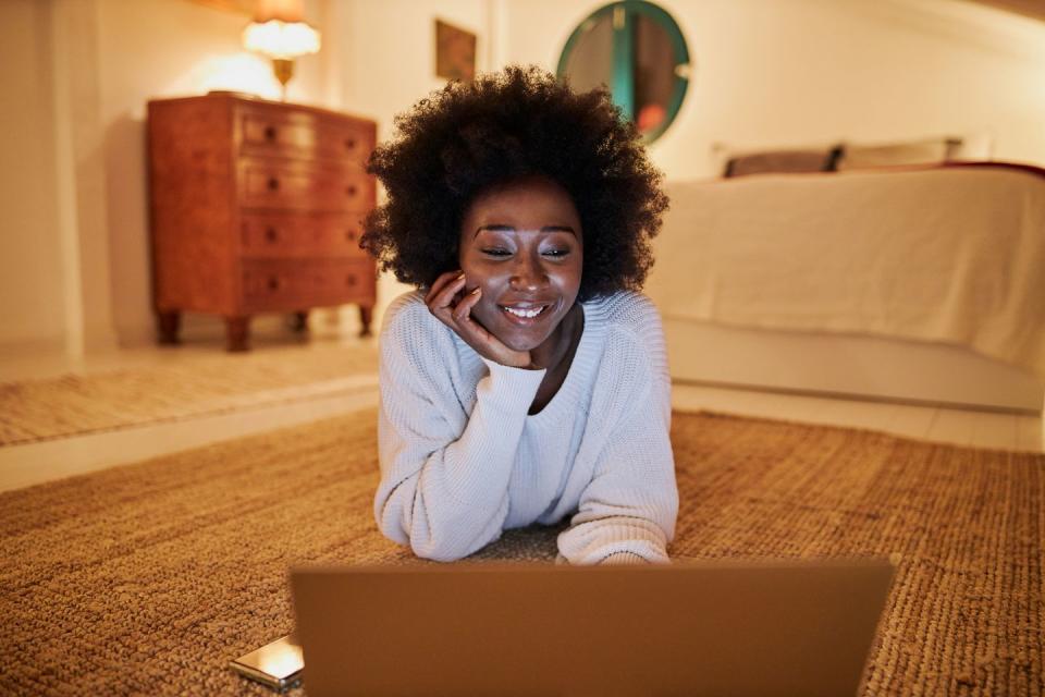 woman surfing the net on her laptop at home
