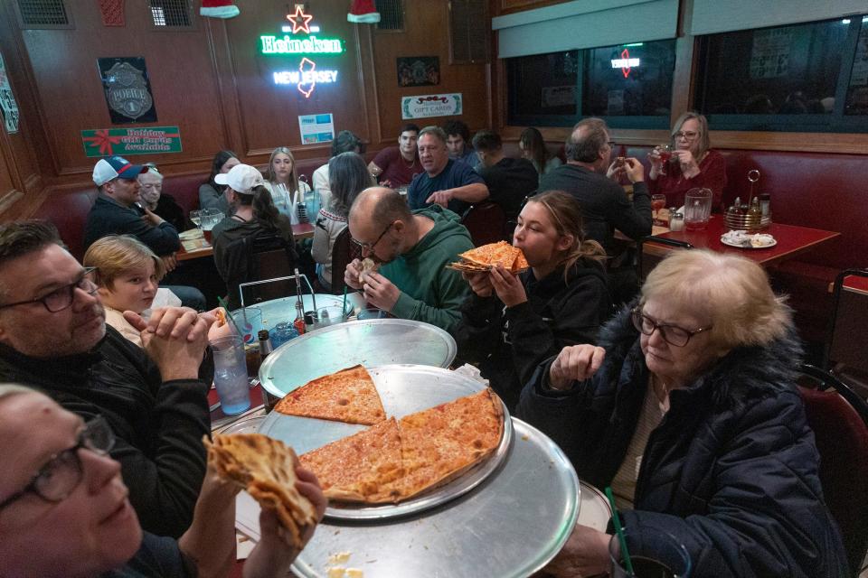 The Larkin Family of Ocean Township take on six pizza pies as part of Camern's Pizza challenge in Pete and Elda's Bar in Neptune City.