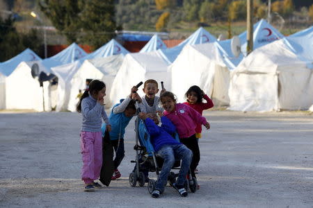 Syrian refugee children play in Yayladagi refugee camp in Hatay province, near the Turkish-Syrian border, Turkey, December 15, 2015. REUTERS/Umit Bektas