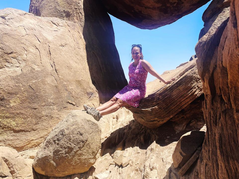 Author Isobella Jade posing on The Balanced Rock in Big Bend 