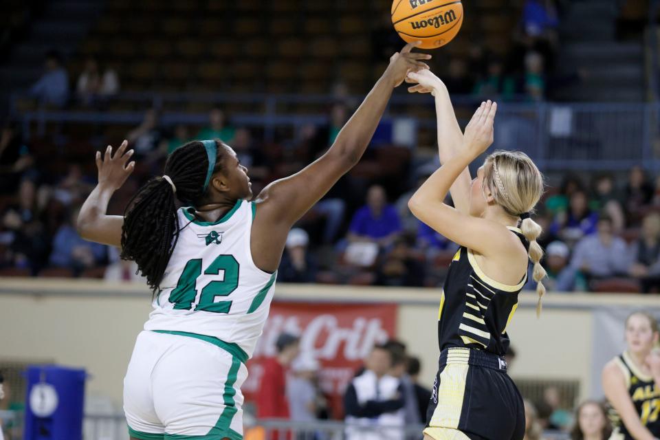Sofi Woodson of Jones blocks the shot of Alva's Channing Ferguson during a Class 3A girls basketball state quarterfinal on Tuesday at State Fair Arena. Jones won 49-34.