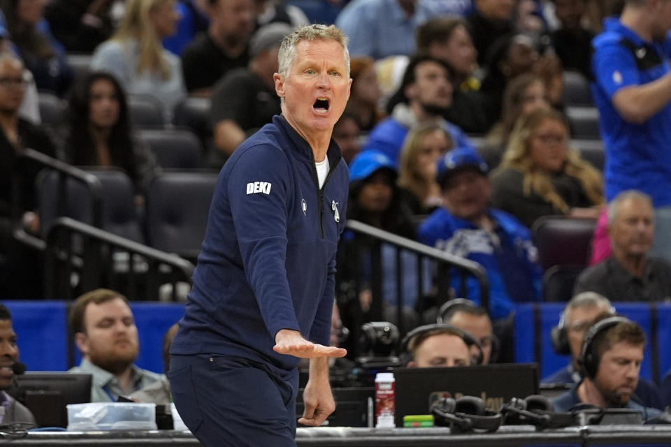 Golden State Warriors coach Steve Kerr shouts to players during the first half of the team's NBA basketball game against the Orlando Magic, Wednesday, March 27, 2024, in Orlando, Fla. (AP Photo/John Raoux)
