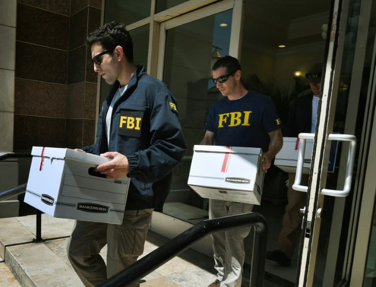 FBI agents remove documents from the offices of the California Investment Immigration Fund in an investigation into an alleged $50 million visa fraud scheme involving as many as 100 Chinese nationals in San Gabriel, California on April 5, 2017