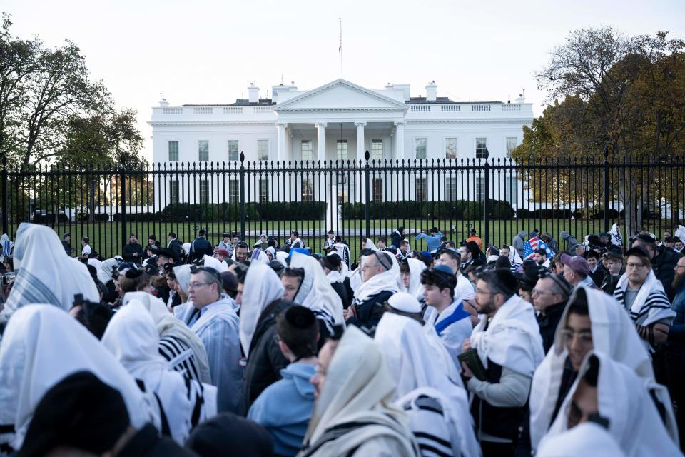 People pray on Pennsylvania Avenue in front of the White House before a rally supporting Israel during its conflict with Hamas, Nov. 14, 2023, in Washington, D.C.  / Credit: BRENDAN SMIALOWSKI/AFP via Getty Images