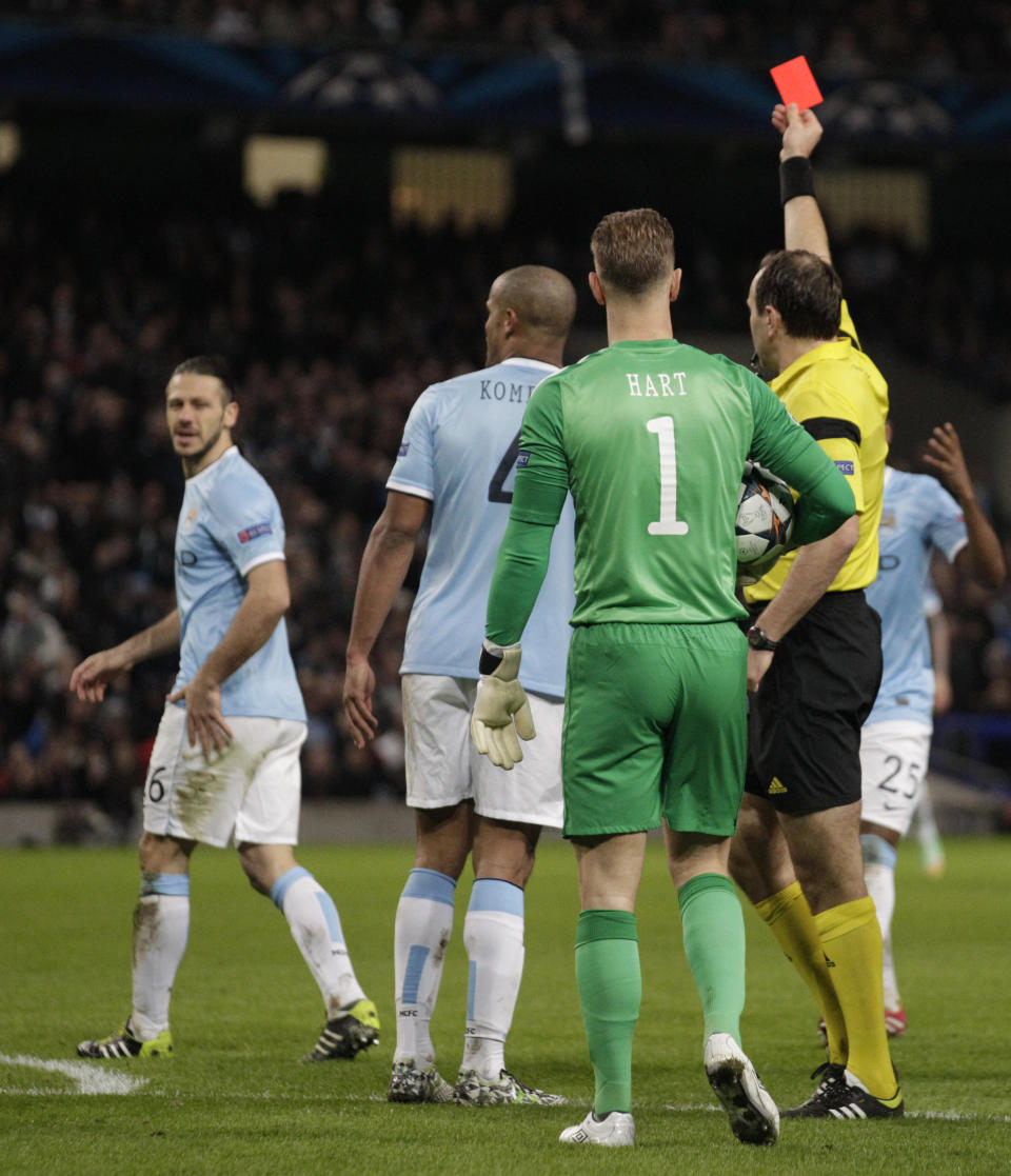 Manchester City's Martin Demichelis is shown a red card by referee Jonas Eriksson during their Champions League first knock out round soccer match at the Etihad Stadium, Manchester, England, Tuesday Feb. 18, 2014. (AP Photo/Jon Super)