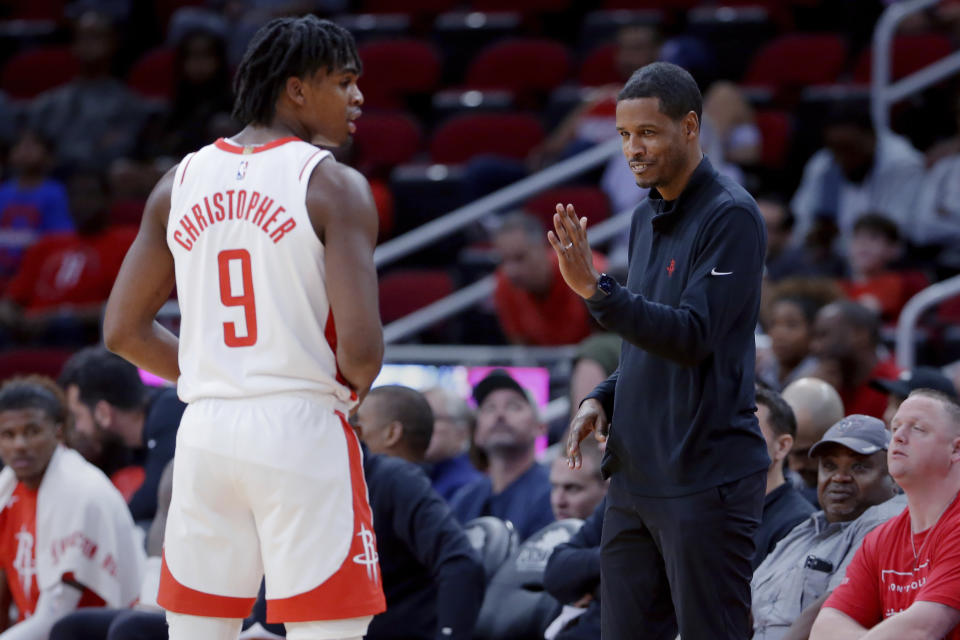 Houston Rockets head coach Stephen Silas, right, talks with Josh Christopher (9) at the bench during the second half of an NBA basketball game against the San Antonio Spurs Sunday, Oct. 2, 2022, in Houston. (AP Photo/Michael Wyke)