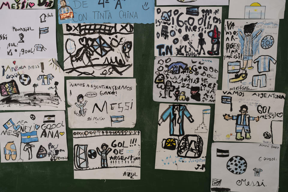 Drawings of soccer player Lionel Messi and the Argentine team, made by students at the General Las Heras elementary school where Messi also attended school, are exhibited on a wall at the school in Rosario, Argentina, Wednesday, Dec. 14, 2022. (AP Photo/Rodrigo Abd)