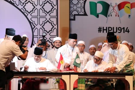 UMNO President Ahmad Zahid Hamidi and PAS President Hadi Awang sign political cooperation charter during Ummah Unity Gathering in Kuala Lumpur