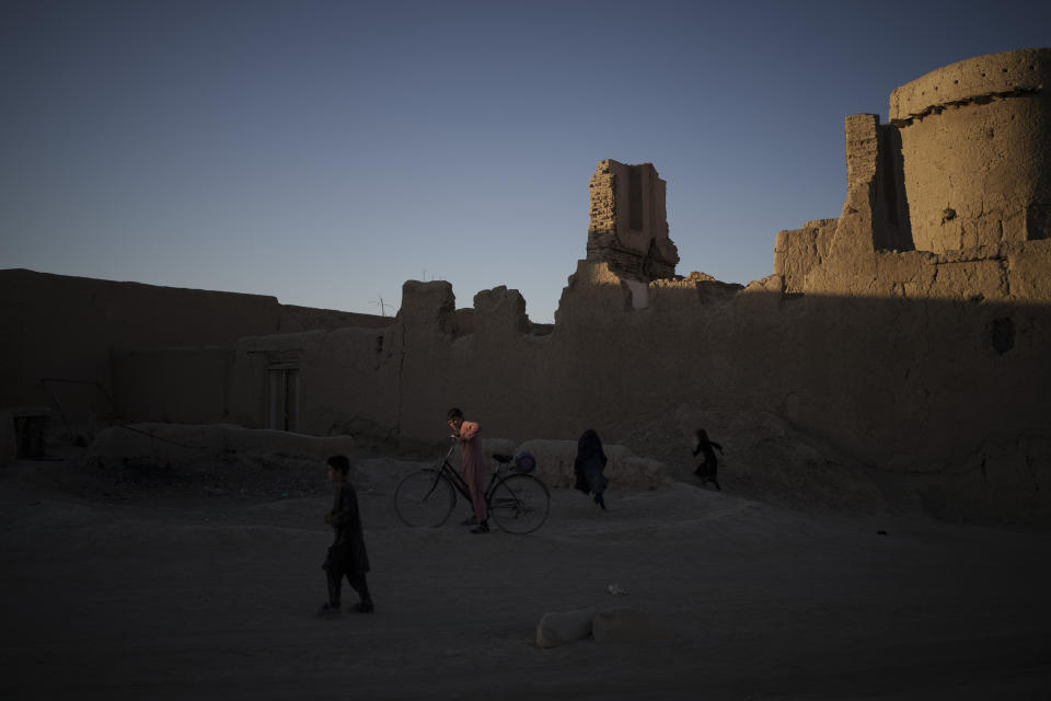 Afghan children play during sunset in Salar village, Wardak province, Afghanistan, Tuesday, Oct. 12, 2021. In urban centers, public discontent toward the Taliban is focused on threats to personal freedoms, including the rights of women. In Salar, these barely resonate. The ideological gap between the Taliban leadership and the rural conservative community is not wide. Many villagers supported the insurgency and celebrated the Aug. 15 fall of Kabul which consolidated Taliban control across the country. (AP Photo/Felipe Dana)