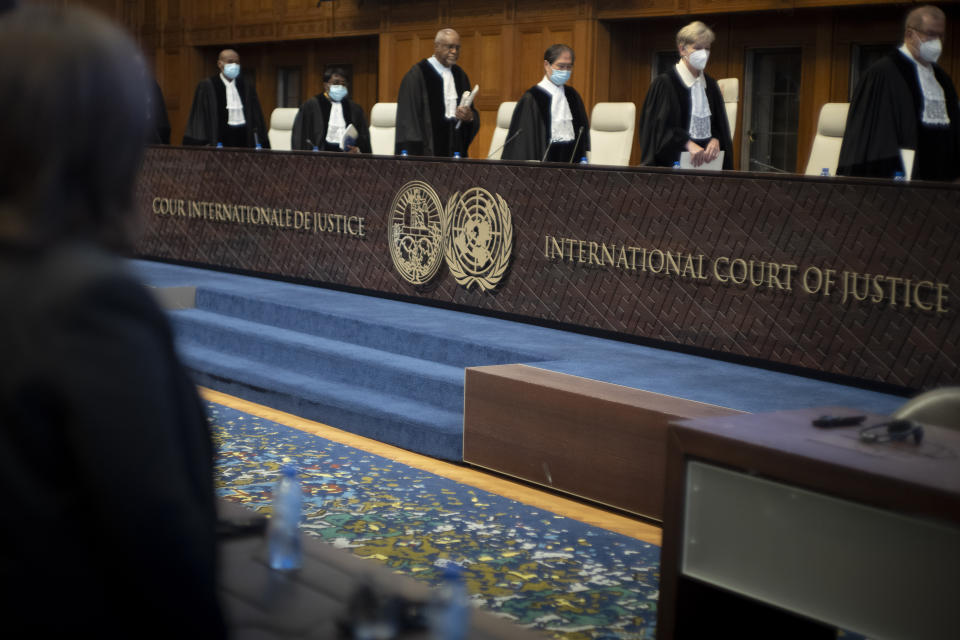 Judges enter the World Court in The Hague, Netherlands, Thursday, Dec. 1, 2022, where the UN's top court ruled on a dispute about a river that crosses Chile's and Bolivia's border, in a case seen as important jurisprudence at a time when fresh water is becoming an increasingly coveted world resource. (AP Photo/Peter Dejong)