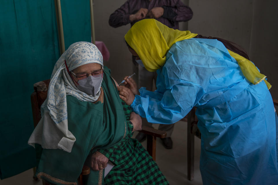 An elderly Kashmiri Ameena Begum receives the Covishield vaccine for COVID-19 at a primary health center in Srinagar, Indian controlled Kashmir, Friday, March 19, 2021. India is third behind the United States and Brazil in total coronavirus infections. (AP Photo/Dar Yasin)