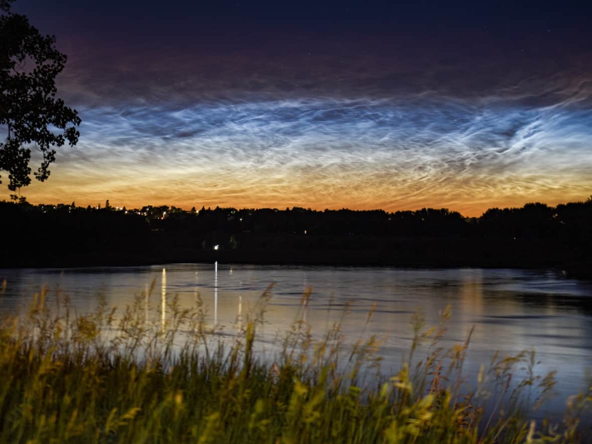 This image shows the beauty of noctilucent clouds over Medicine Hat, Alta., in 2021. This is the best time of year to catch these electric-blue clouds, which appear after sunset and before sunrise. (Submitted by Jackie Armstrong - image credit)
