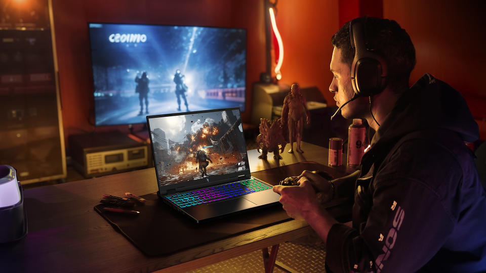 A gamer sits in a luxurious modern lighted gaming room with an Acer gaming laptop.  A second TV shows a different part of the game behind them.