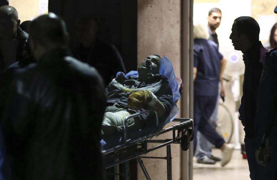 A man on a hospital gurney amid a half-dozen medical staff.