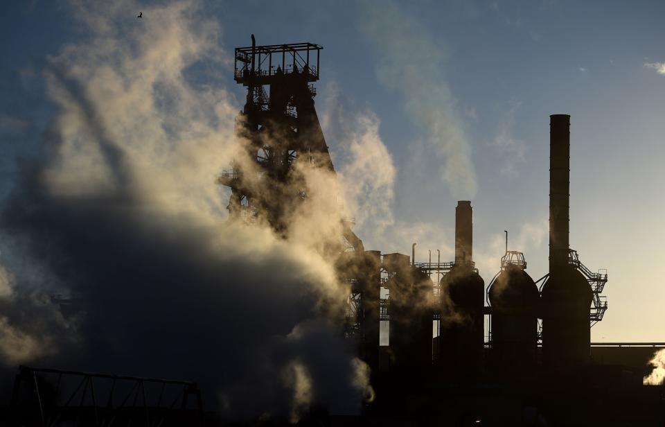 The sun sets behind the Tata steel works in Port Talbot, Wales, as the steel giant confirmed plans to sell its UK assets, threatening thousands of job cuts.