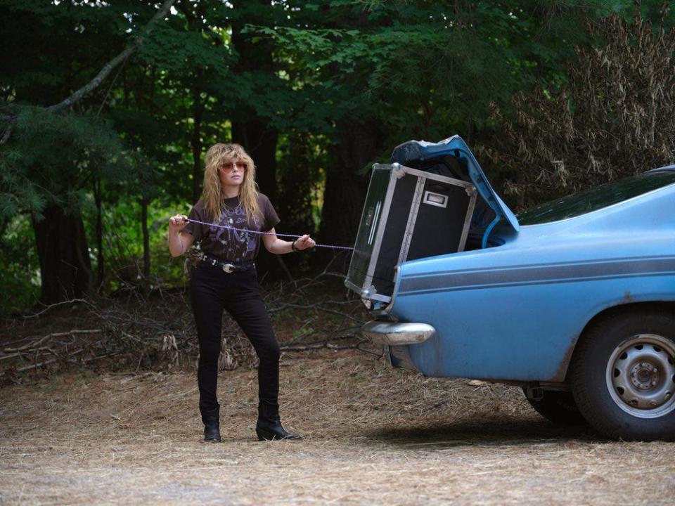 Charlie Cale, played by Natasha Lyonne, loads up her vintage car in a scene from the first season of the Peacock series "Poker Face." The show was created by Rian Johnson as a tribute to his favorite episodic TV shows from the '70s such as "Columbo" and "Murder, She Wrote."