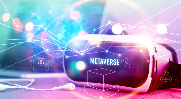 An image of a VR headset and headphones; the word metaverse on the headset