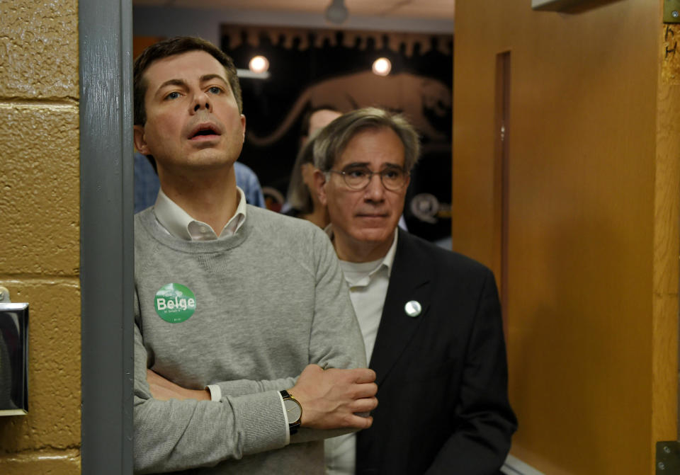 South Bend Mayor Pete Buttigieg, left, waits to speak to the crowd about his Presidential run during the Democratic monthly breakfast held at the Circle of Friends Community Center in Greenville, S.C. Saturday, March 23, 2019. Paul Merlo, right, GCDP volunteer coordinator, waits to escort Mayor Pete into the hall. (AP Photo/Richard Shiro)