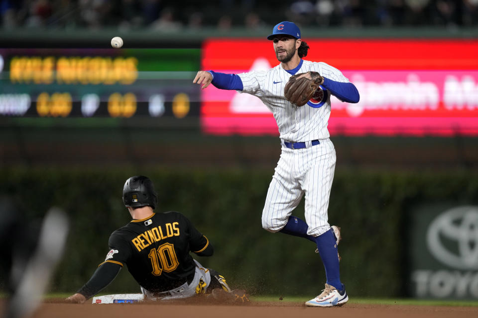 Chicago Cubs shortstop Dansby Swanson throws to first after forcing out Pittsburgh Pirates' Bryan Reynolds at second getting on a double play hit into by Ke'Bryan Hayes during the eighth inning of a baseball game Tuesday, Sept. 19, 2023, in Chicago. (AP Photo/Charles Rex Arbogast)