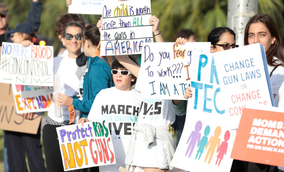 <p>People hold signs while rallying in the street during March for Our Lives, at the Miami Beach Senior High School in Miami, Florida. (Javier Galeano /Reuters) </p>