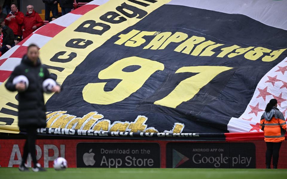 The Kop holds a giant flag to acknowledge the 35th anniversary at Liverpool's home game on Sunday