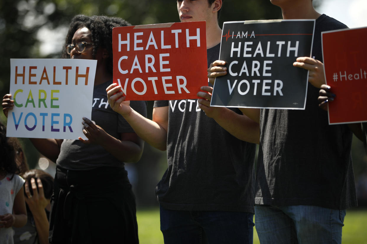 Demonstrators hold signs as Democratic leaders speak with reporters outside the U.S. Capitol on June 26, 2018, in Washington, D.C. (Photo: Aaron P. Bernstein/Getty Images)