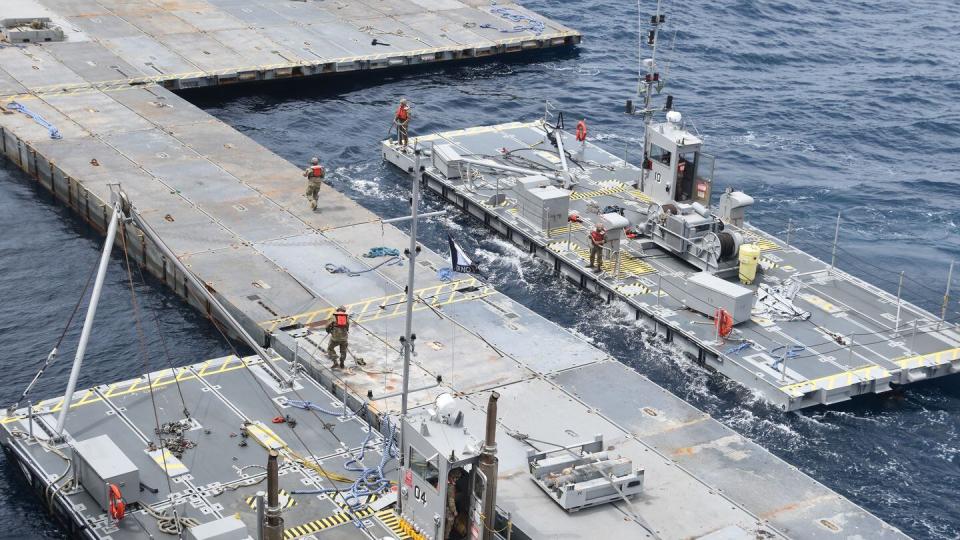 U.S. troops assemble floating barges into larger structures as part of the construction of the floating pier off Gaza. (U.S. Army via AP)