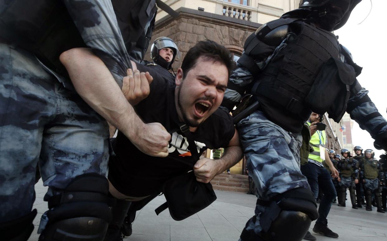 Police officers detain a man during the rally in support of rejected independent candidates - TASS