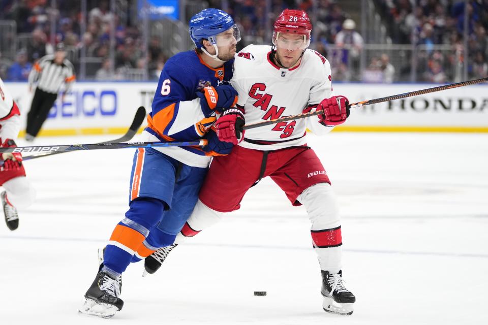 New York Islanders' Ryan Pulock (6) checks Carolina Hurricanes' Paul Stastny during the first period of Game 4 of an NHL hockey Stanley Cup first-round playoff series, Sunday, April 23, 2023, in Elmont, N.Y. (AP Photo/Frank Franklin II)