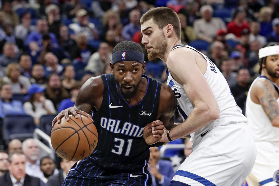 Orlando Magic guard Terrence Ross (31) drives around Minnesota Timberwolves forward Juan Hernangomez during the second half of an NBA basketball game Friday, Feb. 28, 2020, in Orlando, Fla. (AP Photo/John Raoux)