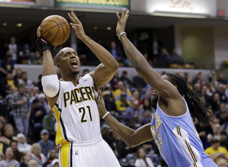 Indiana Pacers forward David West (21) shoots over Denver Nuggets forward Kenneth Faried in the second half of an NBA basketball game in Indianapolis, Monday, Feb. 10, 2014. The Pacers defeated the Nuggets 119-80. (AP Photo/Michael Conroy)