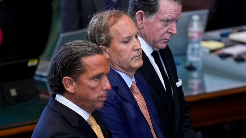 PHOTO: Texas state Attorney General Ken Paxton, center, stands between his attorneys Buzbee, front, and Cogdell, rear, as the articles of his impeachment are read during the his impeachment trial in the Senate Chamber at the Texas Capitol, Sept. 5, 2023. (Eric Gay/AP)