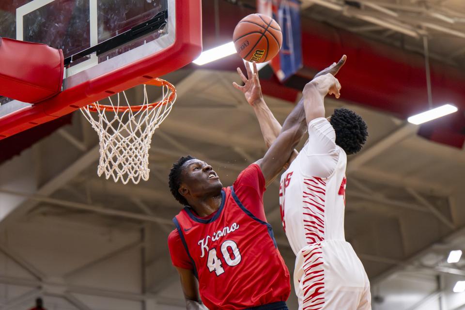 Kokomo High School senior Flory Bidunga (40) blocks a shot by Fishers High School junior JonAnthony Hall (22) during the first half of a game in the Forum Tipoff Classic, Saturday, Dec. 9, 2023, at Southport High School.