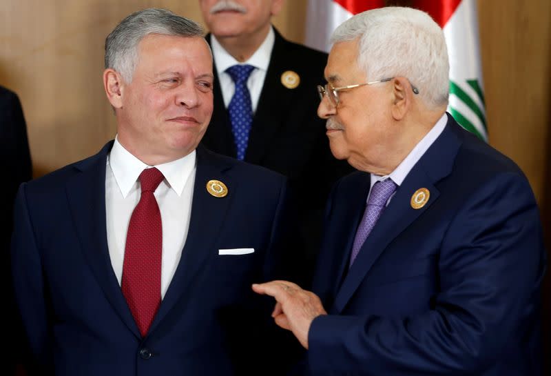 FILE PHOTO: Jordan's King Abdullah II speaks with Palestinian President Mahmoud Abbas during the group photo with Arab leaders, ahead of the 30th Arab Summit in Tunis