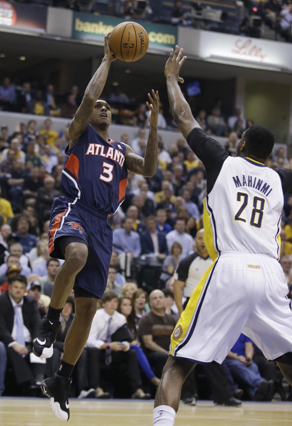 Atlanta Hawks' Louis Williams (3) shoot against Indiana Pacers' Ian Mahinmi during the first half in Game 2 of an opening-round NBA basketball playoff series Tuesday, April 22, 2014, in Indianapolis. (AP Photo/Darron Cummings)