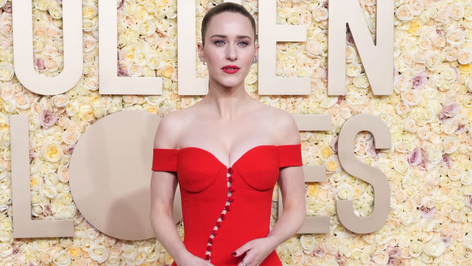 “The Marvelous Mrs. Maisel” star Rachel Brosnahan wore a sculptural red off-shoulder button-up Sergio Hudson dress with peep toe sandals. - Jordan Strauss/Invision/AP