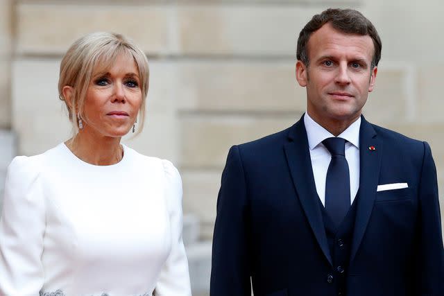 <p>Chesnot/Getty</p> Emmanuel Macron and Brigitte Macron stand side-by-side prior to a state dinner with Italian President Sergio Mattarella and his his daughter Laura Mattarella at the Elysee Presidential Palace on July 05, 2021.